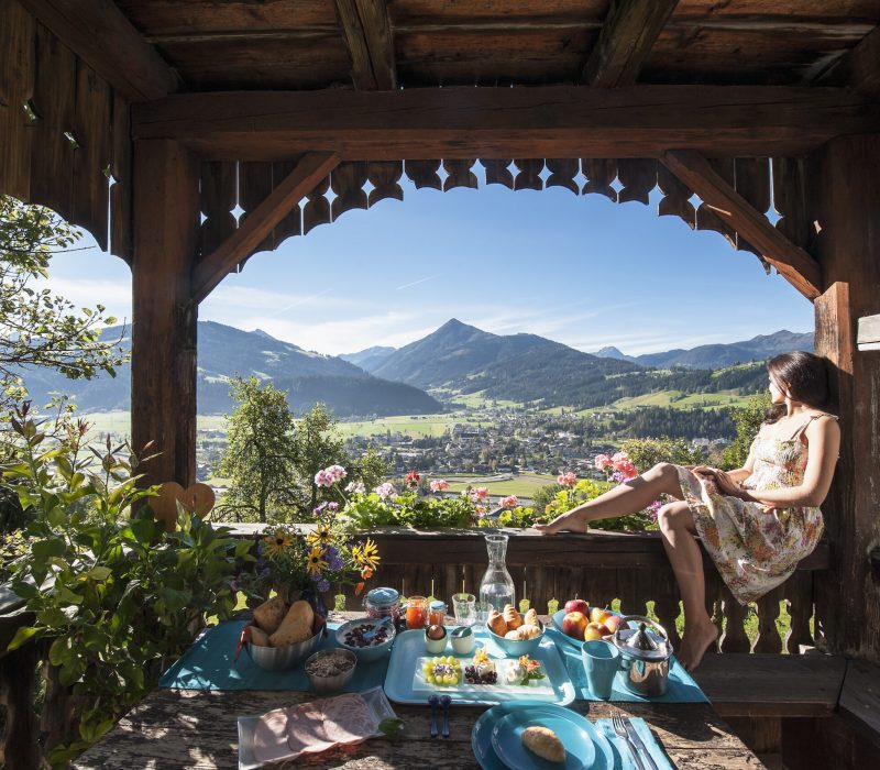 Austria, Salzburg State, Altenmarkt-Zauchense, woman enjoying view from veranda of old farmhouse Austria, Salzburg State, Altenmarkt-Zauchense, woman enjoying view from veranda of old farmhouse